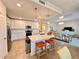 Modern kitchen with white cabinets, quartz countertops, and stainless steel appliances at 10059 Crooked Creek Dr # 102, Venice, FL 34293
