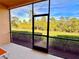 Screened patio with view of lush landscaping at 10059 Crooked Creek Dr # 102, Venice, FL 34293