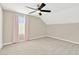 Bright bedroom with carpeted floor, ceiling fan, and window with pink curtains at 10814 Newbridge Dr, Riverview, FL 33579