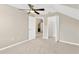 Spacious bedroom with a ceiling fan and access to a hallway at 10814 Newbridge Dr, Riverview, FL 33579