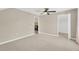Spacious bedroom with neutral walls, ceiling fan, and access to a closet and bathroom at 10814 Newbridge Dr, Riverview, FL 33579