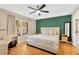Spacious bedroom with a king-size bed, an accent wall, and a home office at 10814 Newbridge Dr, Riverview, FL 33579