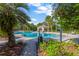 Resort-style pool with palm trees and a covered patio at 10814 Newbridge Dr, Riverview, FL 33579