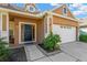 Front entrance with a dark-colored door and nicely landscaped area at 10814 Newbridge Dr, Riverview, FL 33579