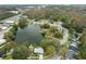 House near a lake with surrounding houses and road at 1125 Westwood Dr, Lutz, FL 33549