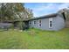 Gray house exterior with a screened porch and backyard at 1125 Westwood Dr, Lutz, FL 33549