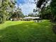 Large backyard with spacious lawn, fire pit, and detached building at 11554 Monette Rd, Riverview, FL 33569