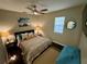 Cozy bedroom with a queen-size bed and dark wood flooring at 11554 Monette Rd, Riverview, FL 33569
