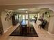 Bright dining room with a long wooden table, and access to the backyard at 11554 Monette Rd, Riverview, FL 33569