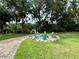 Peaceful firepit area with comfortable seating nestled amongst trees at 11554 Monette Rd, Riverview, FL 33569