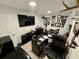 Spacious home office with large TV, desk, and wall of framed photos at 11554 Monette Rd, Riverview, FL 33569