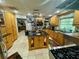 Open kitchen with island, stainless steel appliances, and wood cabinets at 11554 Monette Rd, Riverview, FL 33569