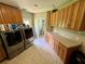 Bright laundry room with washer, dryer, and built-in cabinets at 11554 Monette Rd, Riverview, FL 33569