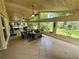Relaxing screened porch with tiled floor, wicker furniture, and views of the backyard at 11554 Monette Rd, Riverview, FL 33569
