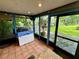 Bright screened-in room with backyard view, featuring tiled floor at 11554 Monette Rd, Riverview, FL 33569