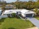 Aerial view of a renovated mid-century modern home with a large yard at 1448 S Hercules Ave, Clearwater, FL 33764