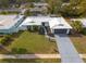 Aerial view of a single-Gathering home with a gray driveway and well-manicured lawn at 1448 S Hercules Ave, Clearwater, FL 33764