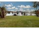 Large backyard with grassy lawn and a view of the house at 1448 S Hercules Ave, Clearwater, FL 33764