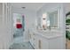 Modern bathroom with double vanity, white cabinets, and blue tile floors at 1448 S Hercules Ave, Clearwater, FL 33764