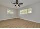 Bright bedroom featuring light wood floors and ceiling fan at 1448 S Hercules Ave, Clearwater, FL 33764