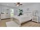 Main bedroom with a light pink comforter, nightstands, and a ceiling fan at 1448 S Hercules Ave, Clearwater, FL 33764
