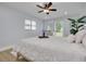 Bright bedroom with a comfortable bed, a ceiling fan and large windows at 1448 S Hercules Ave, Clearwater, FL 33764