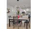 Bright dining room features a marble table, black chairs, and a modern light fixture at 1448 S Hercules Ave, Clearwater, FL 33764