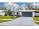 Updated mid-century modern home with a two-car garage and well-manicured lawn at 1448 S Hercules Ave, Clearwater, FL 33764