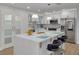 Modern kitchen with white cabinets, a large island, and stainless steel appliances at 1448 S Hercules Ave, Clearwater, FL 33764