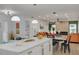 Open concept kitchen with white cabinets and a view into the living room at 1448 S Hercules Ave, Clearwater, FL 33764