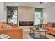 Living room features a modern fireplace, orange couches, and a coffee table at 1448 S Hercules Ave, Clearwater, FL 33764