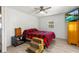 Bedroom with a red and black plaid comforter and ceiling fan at 14912 Brookridge Blvd, Brooksville, FL 34613