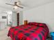 Bedroom with a red and black plaid comforter and view to bathroom at 14912 Brookridge Blvd, Brooksville, FL 34613