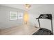 Bedroom with treadmill and floor-to-ceiling windows at 14912 Brookridge Blvd, Brooksville, FL 34613