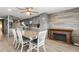 Dining area with light wood table and chairs, and a fireplace at 14912 Brookridge Blvd, Brooksville, FL 34613