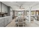 Bright dining area with wood-look flooring, and view into the living room at 14912 Brookridge Blvd, Brooksville, FL 34613