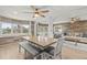Dining area with bench seating and view to living room and large windows at 14912 Brookridge Blvd, Brooksville, FL 34613