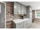 Modern kitchen with gray cabinets, white countertops, and tile backsplash at 14912 Brookridge Blvd, Brooksville, FL 34613