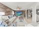 Spacious living room with wood-look floors, large TV, and comfy seating at 14912 Brookridge Blvd, Brooksville, FL 34613