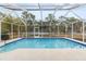 Inviting screened pool with solar panels at 14912 Brookridge Blvd, Brooksville, FL 34613