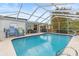 Refreshing pool with screened enclosure and patio furniture at 14912 Brookridge Blvd, Brooksville, FL 34613