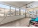 Sunroom with large windows, ceiling fan, and seating area at 14912 Brookridge Blvd, Brooksville, FL 34613