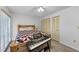 Bedroom with wooden bed frame and a keyboard at 1725 Pine Ridge E Way # E, Palm Harbor, FL 34684