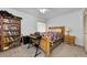 Bedroom with wooden bed frame and a keyboard at 1725 Pine Ridge E Way # E, Palm Harbor, FL 34684