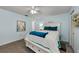 Cozy bedroom with light blue walls and a comfortable queen bed at 1725 Pine Ridge E Way # E, Palm Harbor, FL 34684