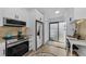 Modern kitchen with stainless steel appliances and white cabinetry at 1725 Pine Ridge E Way # E, Palm Harbor, FL 34684