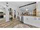 Open concept kitchen features granite countertops and white cabinets at 1725 Pine Ridge E Way # E, Palm Harbor, FL 34684