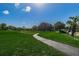 Curving walking path through green lawn at 1725 Pine Ridge E Way # E, Palm Harbor, FL 34684