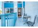 Private balcony with table and chairs, offering a relaxing space at 175 Medallion Blvd # F, Madeira Beach, FL 33708