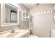 Small bathroom with toilet, sink, and stacked washer/dryer at 175 Medallion Blvd # F, Madeira Beach, FL 33708
